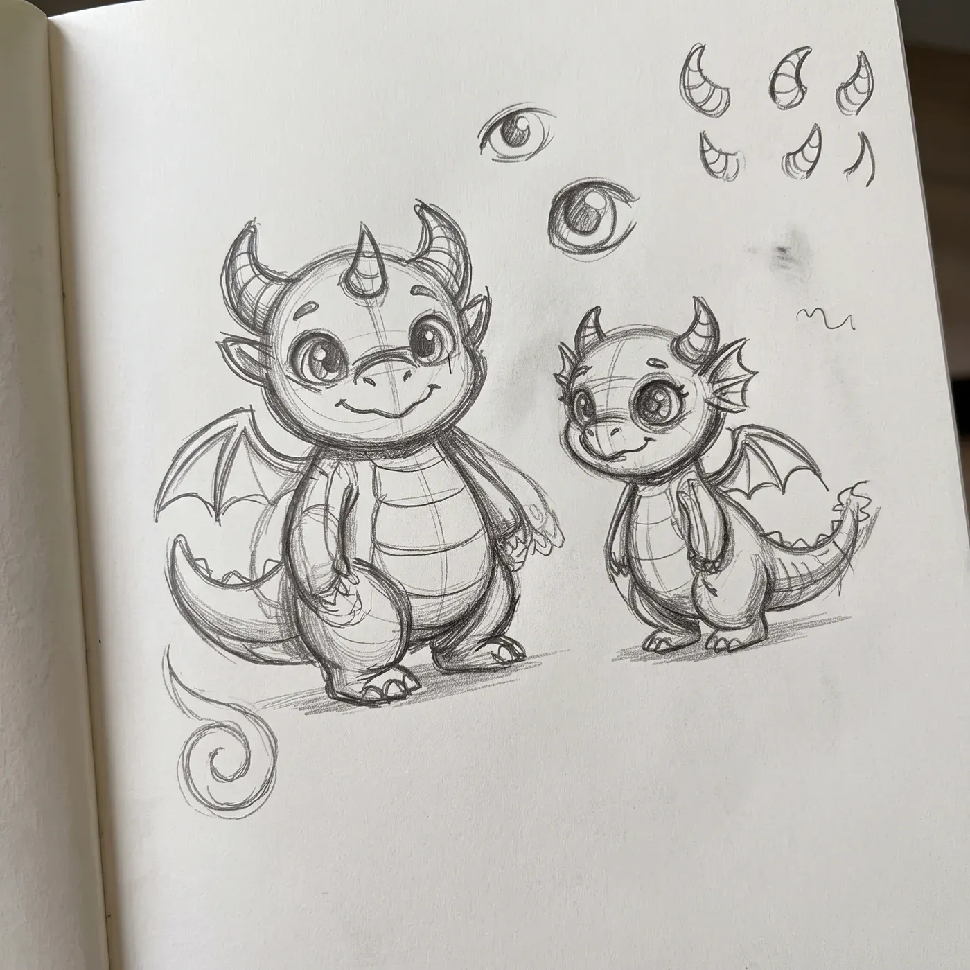 Pencil sketch of Draquis and Mipis in a notebook